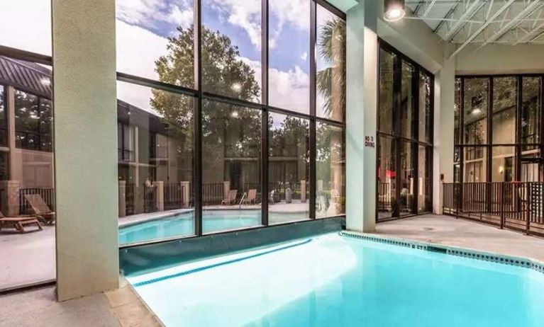 Combo indoor-outdoor pool with seating area at Red Roof PLUS+ & Suites Houston - IAH Airport SW.