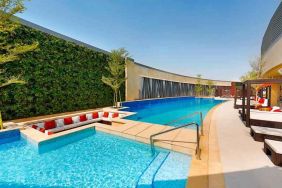 Relaxing outdoor pool at the AlRayyan Hotel Doha, Curio Collection by Hilton.