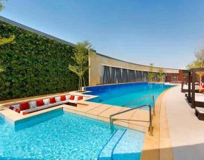 Relaxing outdoor pool at the AlRayyan Hotel Doha, Curio Collection by Hilton.