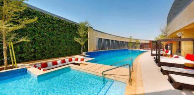 Relaxing outdoor pool at the AlRayyan Hotel Doha, Curio Collection by Hilton.