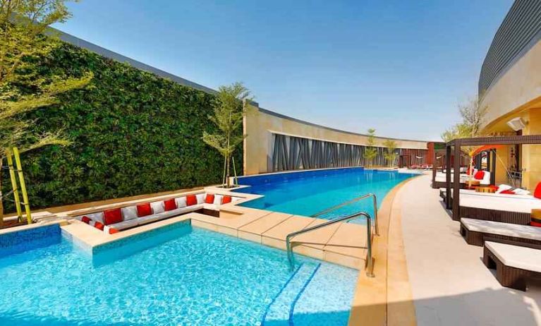 Relaxing outdoor pool at the AlRayyan Hotel Doha, Curio Collection by Hilton.