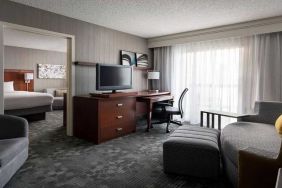 Luxurious king suite with lounge, TV, and work desk at Sonesta Select Phoenix Chandler.