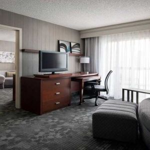 Luxurious king suite with lounge, TV, and work desk at Sonesta Select Phoenix Chandler.