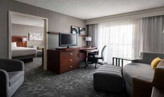 Luxurious king suite with lounge, TV, and work desk at Sonesta Select Phoenix Chandler.