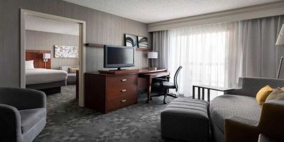 Luxurious king suite with lounge, TV, and work desk at Sonesta Select Phoenix Chandler.