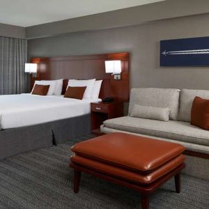 Guest room with sofa at Courtyard By Marriott Los Angeles LAX/Century Boulevard.