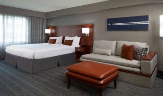 Guest room with sofa at Courtyard By Marriott Los Angeles LAX/Century Boulevard.