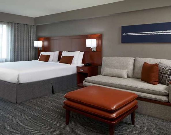 Guest room with sofa at Courtyard By Marriott Los Angeles LAX/Century Boulevard.