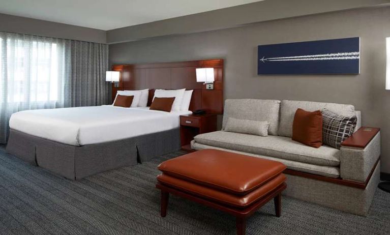 Guest room with sofa at Courtyard By Marriott Los Angeles LAX/Century Boulevard.