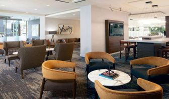 Seating area with TV screen at Courtyard By Marriott Los Angeles LAX/Century Boulevard.