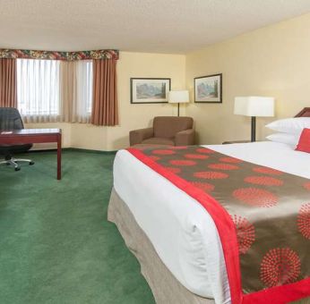 Hotel bedroom with workstation at Riviera Plaza And Conference Centre Calgary Airport.