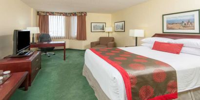 Hotel bedroom with workstation at Riviera Plaza And Conference Centre Calgary Airport.