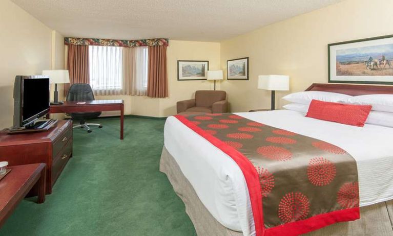 Hotel bedroom with workstation at Riviera Plaza And Conference Centre Calgary Airport.