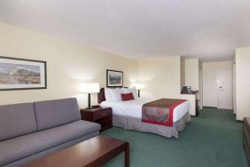 Queen room with sofa at Riviera Plaza And Conference Centre Calgary Airport.