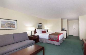 Queen room with sofa at Riviera Plaza And Conference Centre Calgary Airport.