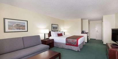 Queen room with sofa at Riviera Plaza And Conference Centre Calgary Airport.