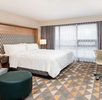 King bedroom with workstation at Holiday Inn Toronto Airport East.