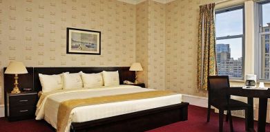 King bedroom with desk at Congress Plaza Hotel.