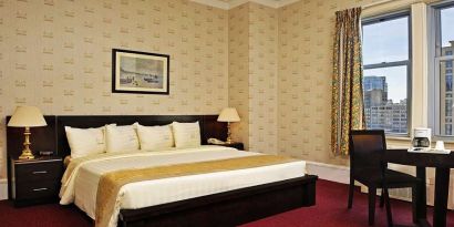 King bedroom with desk at Congress Plaza Hotel.