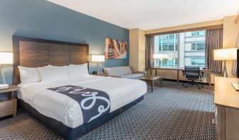 King bedroom with desk and sofa at La Quinta Inn & Suites By Wyndham Chicago Downtown.