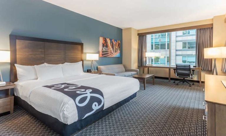 King bedroom with desk and sofa at La Quinta Inn & Suites By Wyndham Chicago Downtown.