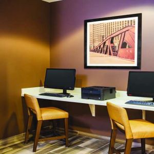 Business center with computers and printer at La Quinta Inn & Suites By Wyndham Chicago Downtown.