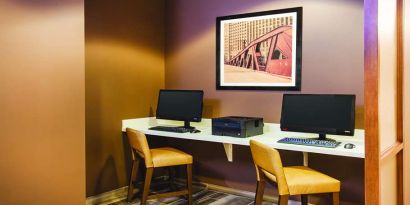 Business center with computers and printer at La Quinta Inn & Suites By Wyndham Chicago Downtown.