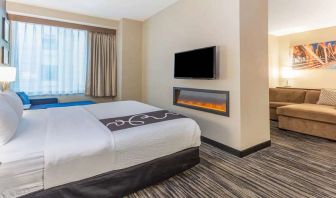 Hotel suite with fireplace and TV screen at La Quinta Inn & Suites By Wyndham Chicago Downtown.