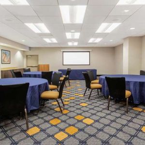 Meeting room with round tables at La Quinta Inn & Suites By Wyndham Chicago Downtown.