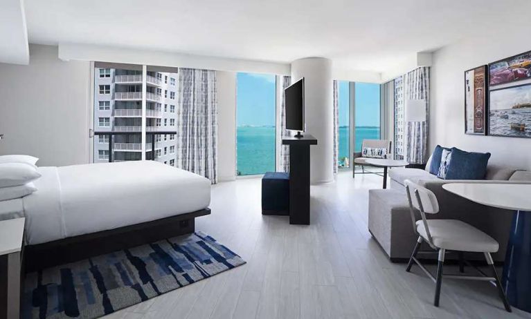 Hotel suite with TV screen, sofa and workstation at Hyatt Centric Brickell Miami.