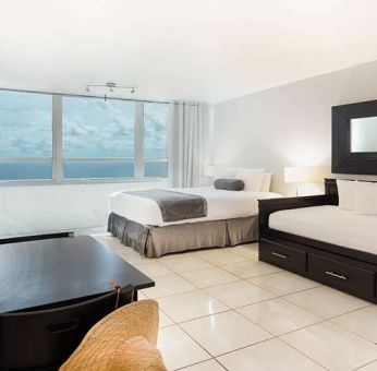 Queen room with workstation at New Point Miami.