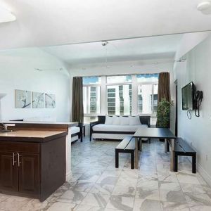 Living room with kitchenette and workspace at New Point Miami.