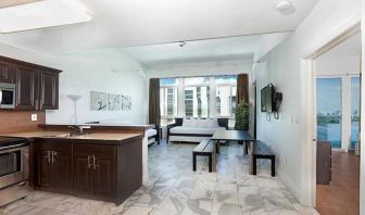 Living room with kitchenette and workspace at New Point Miami.