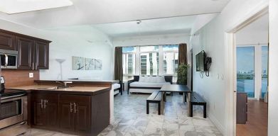 Living room with kitchenette and workspace at New Point Miami.