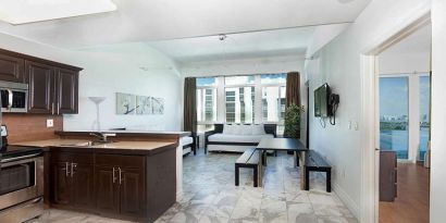 Living room with kitchenette and workspace at New Point Miami.