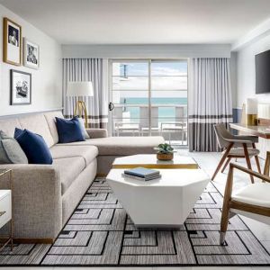 Living room with l shape sofa at Cadillac Hotel & Beach Club, Autograph Collection.