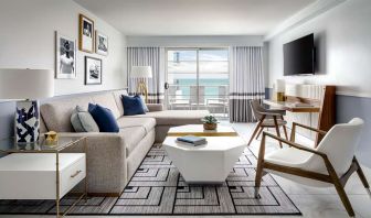 Living room with l shape sofa at Cadillac Hotel & Beach Club, Autograph Collection.