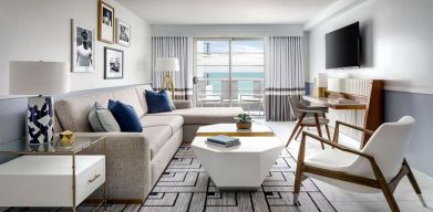 Living room with l shape sofa at Cadillac Hotel & Beach Club, Autograph Collection.