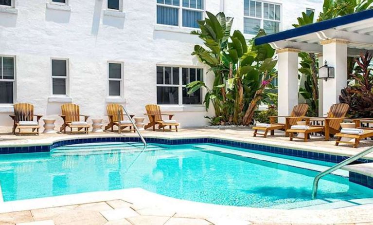 Outdoor pool with lounges at Blue Moon Hotel.