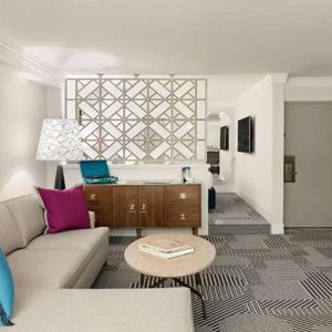 Living room with fireplace in a hotel suite at Le Parc.