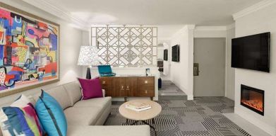 Living room with fireplace in a hotel suite at Le Parc.