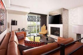 Beautiful hotel suite with sofa, fireplace and TV screen at Le Montrose.