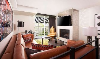 Beautiful hotel suite with sofa, fireplace and TV screen at Le Montrose.