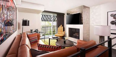 Beautiful hotel suite with sofa, fireplace and TV screen at Le Montrose.