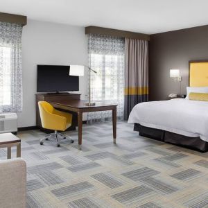 Spacious king bedroom with sofa at Hampton Inn & Suites Los Angeles/ Hollywood.