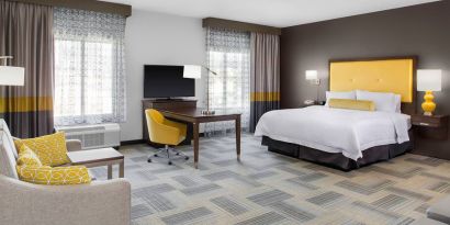 Spacious king bedroom with sofa at Hampton Inn & Suites Los Angeles/ Hollywood.