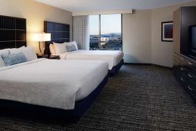 Twin room with TV screen and sofa at Embassy Suites By Hilton LAX Airport North.