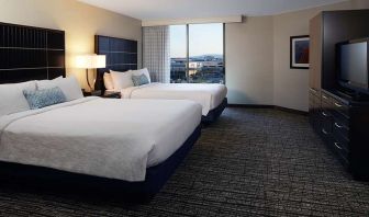 Twin room with TV screen and sofa at Embassy Suites By Hilton LAX Airport North.