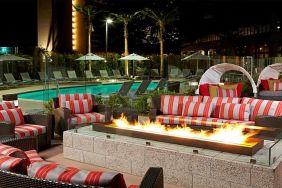 Beautiful outdoor patio by the pool with firepit at Residence Inn By Marriott LAX Airport.