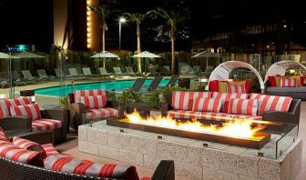 Beautiful outdoor patio by the pool with firepit at Residence Inn By Marriott LAX Airport.